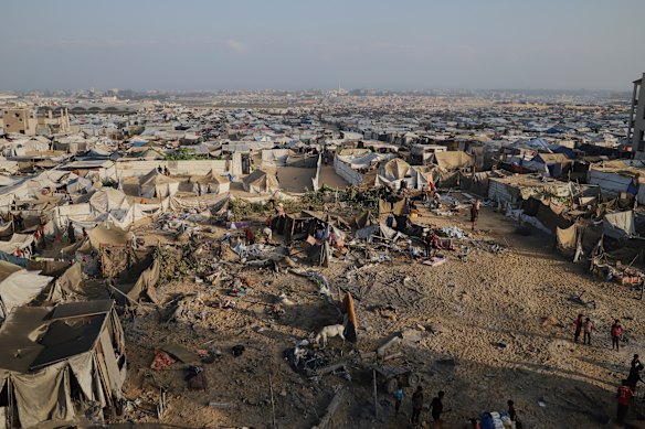 Los palestinos inspeccionan un sitio golpeado por un bombardeo israelí en Muwasi.
